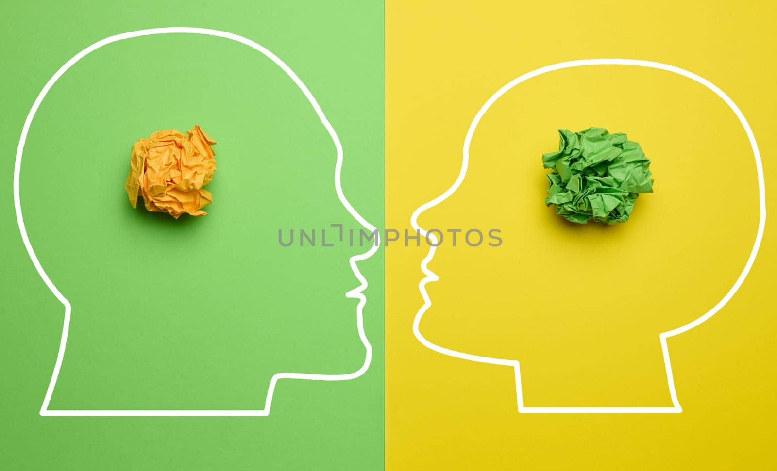 Two silhouettes of a man and a woman's heads with crumpled balls of paper inside, depicting the concept of mutual understanding and new ideas