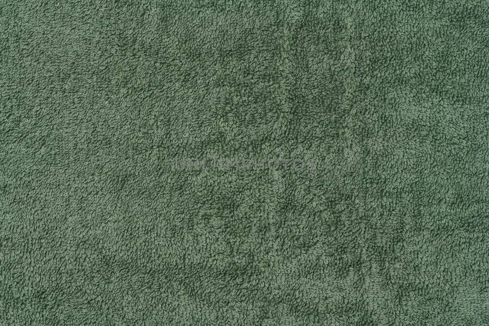 Texture of a green terry cotton towel, canvas. Macro