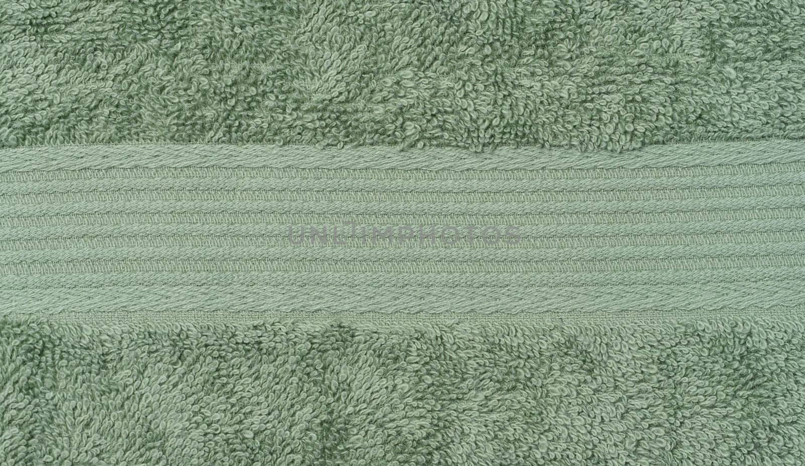 Texture of a green terry cotton towel, canvas. Macro