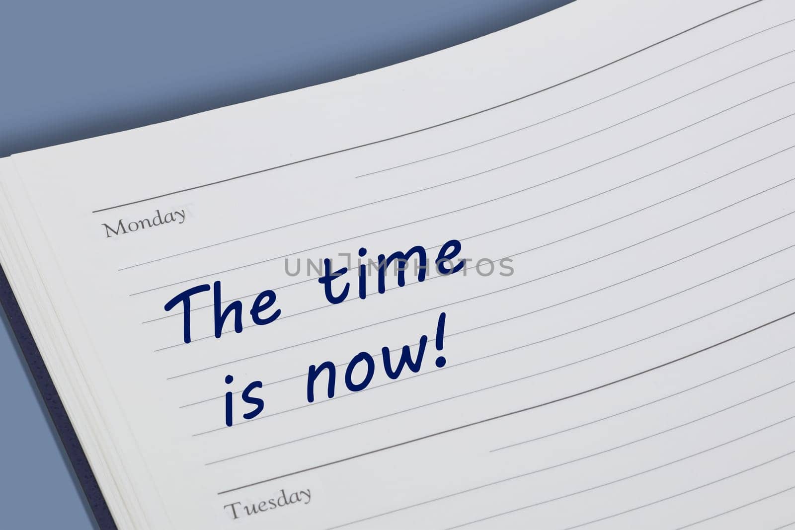 A The time is now diary reminder open on desk
