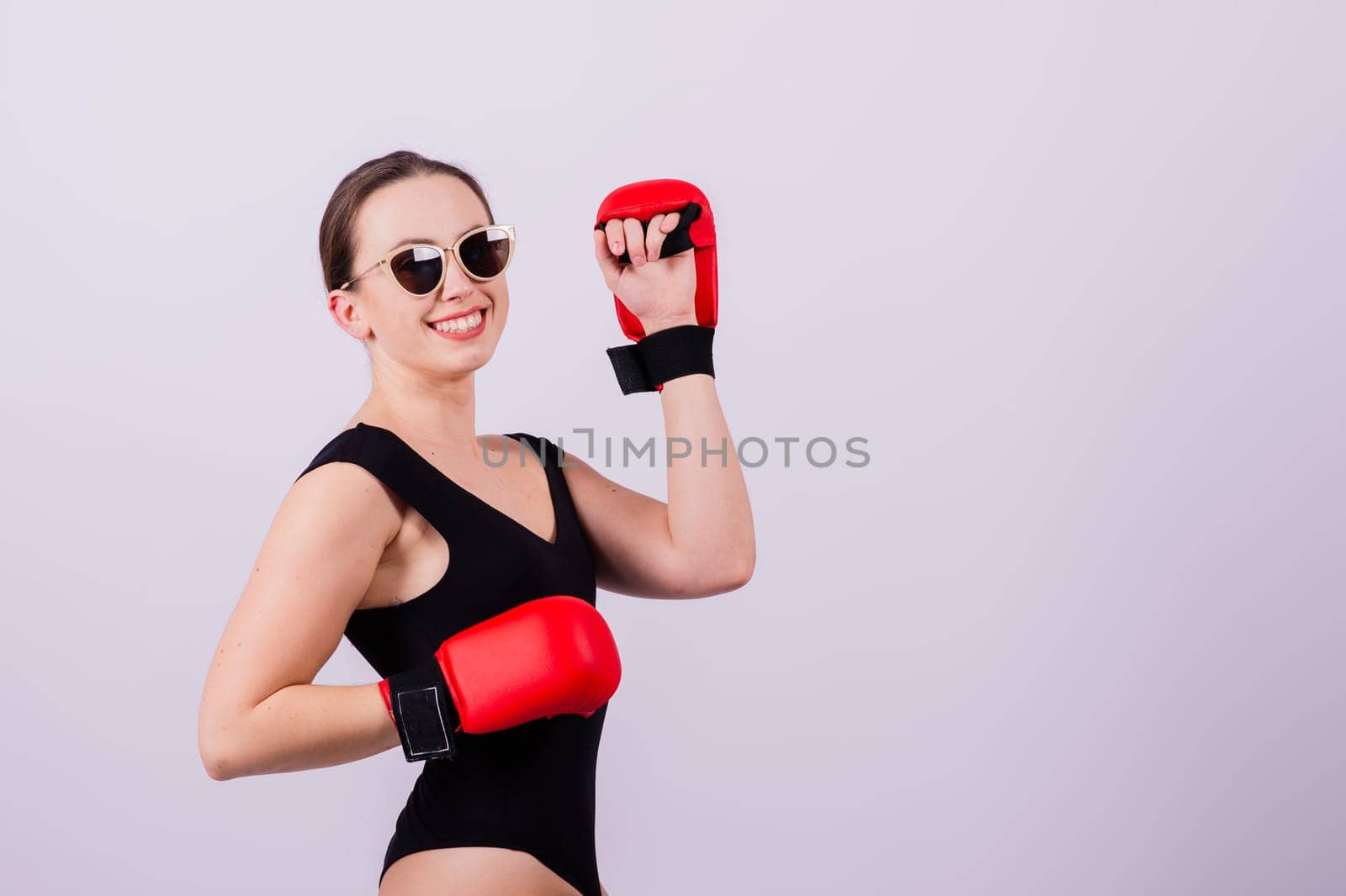 Studio portrait of seductive boxer female in black bodysuit