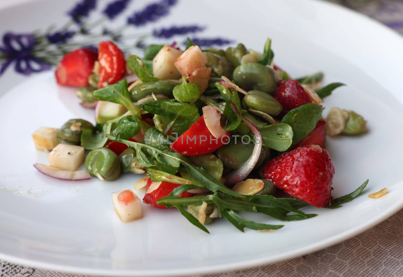 salad with strawberries and broad beans. Delicious dish in a healthy style