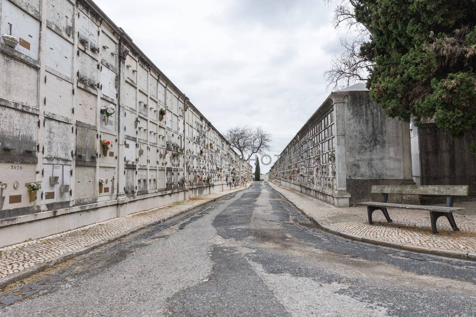 February 22, 2023 Lisbon, Portugal: Alto de Sao Joao Cemetery - a path leading to the sea surrounded by crematorian graves. Mid shot