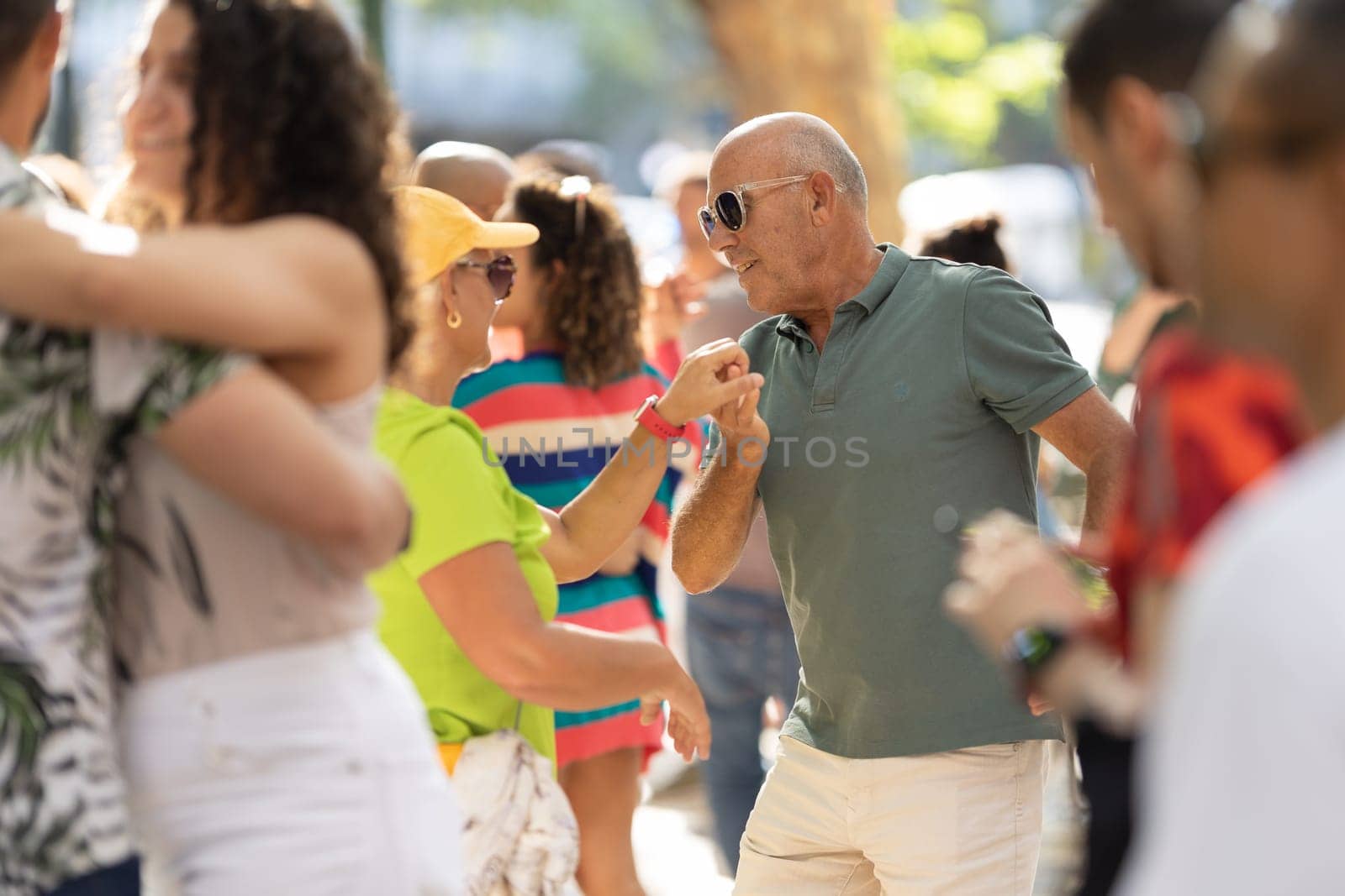 11 JUNE 2023, Lisbon, Portugal - Avenida da Liberdade: cute old couple dancing bachata on the street. Mid shot