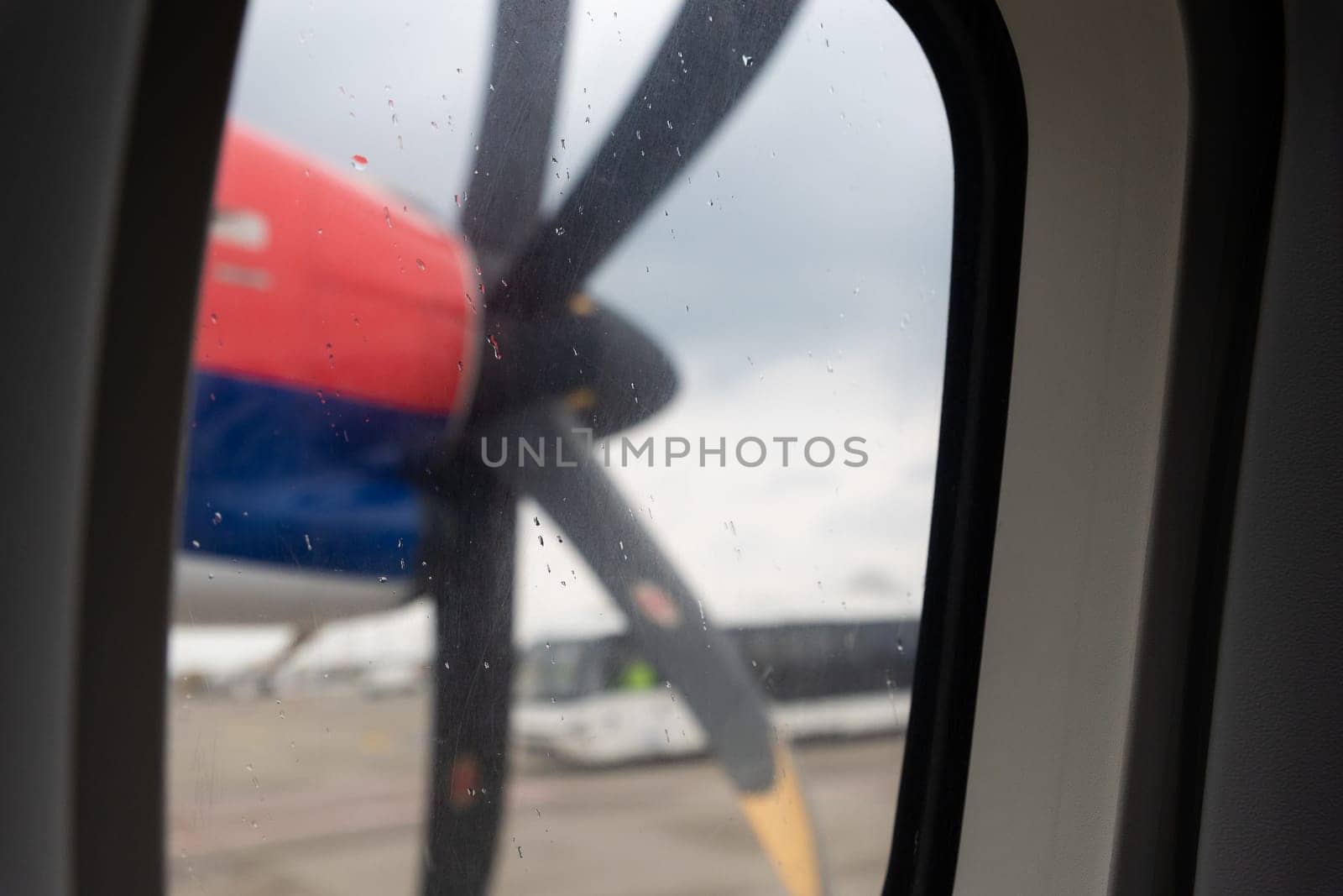 Propeller on the wing of an airplane - view from the window. Mid shot
