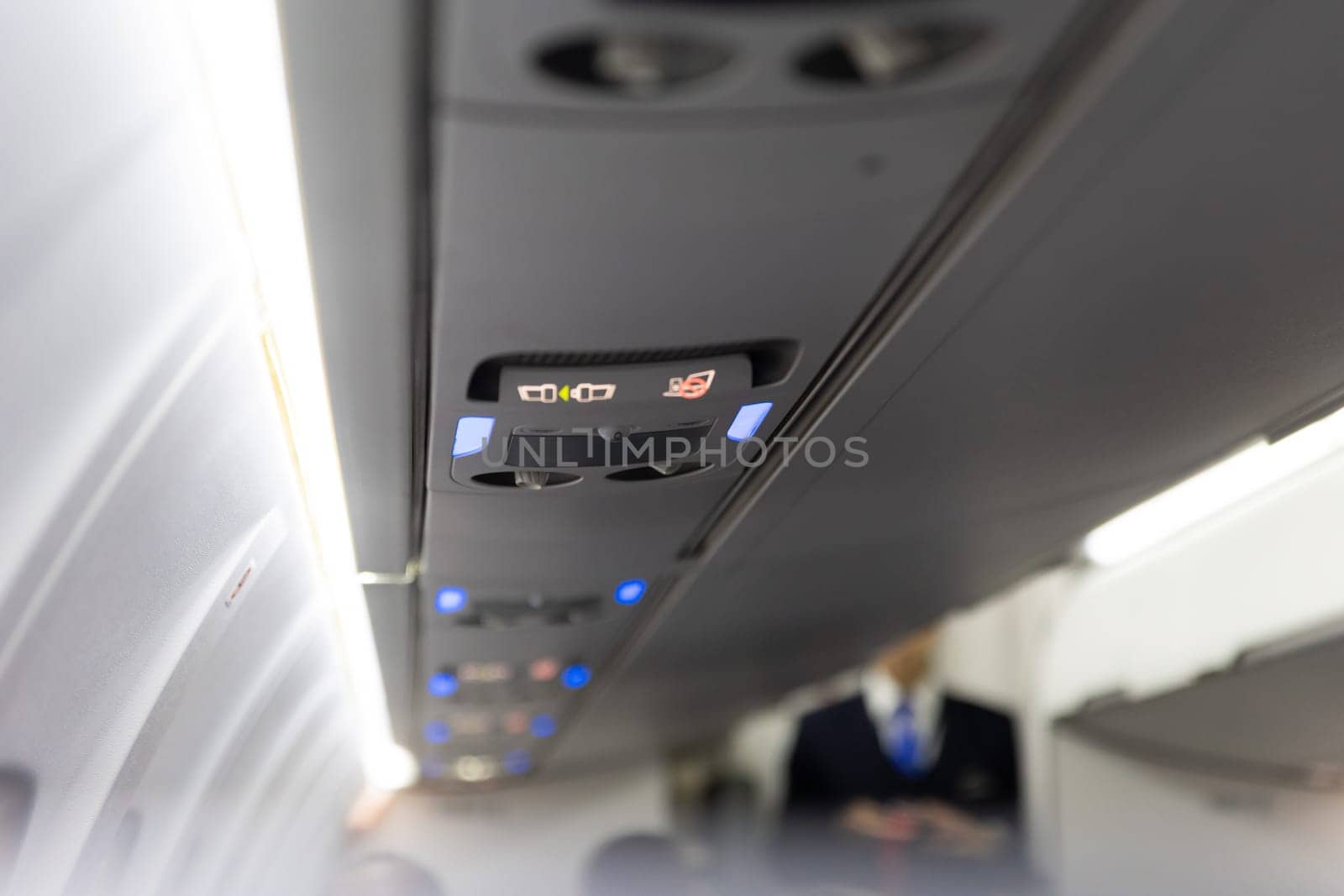 Burning No Smoking Sign and Fasten Seat Belt on Board Aircraft. Mid shot