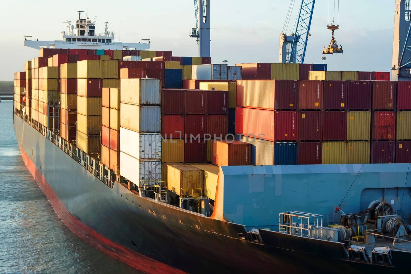 Cargo container ship carrying container under big crane loading cargo import and export service transportation concept.