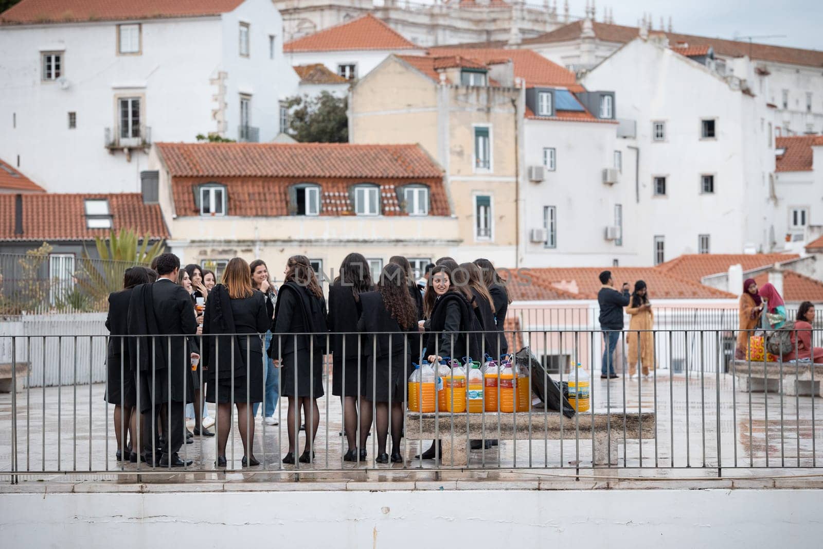 21 April 2023 Lisbon, Portugal: Alfama - Group of girls students celebrate the student holidays with many homemade alcohol drinks. Mid shot
