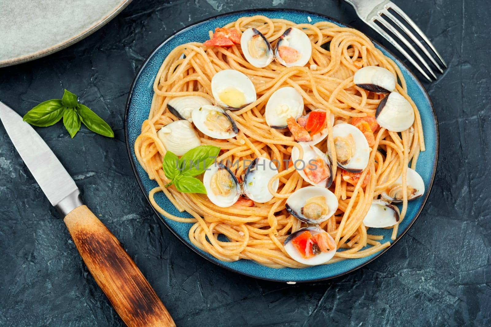 Pasta with clams and spaghetti on a light background. Traditional italian seafood pasta