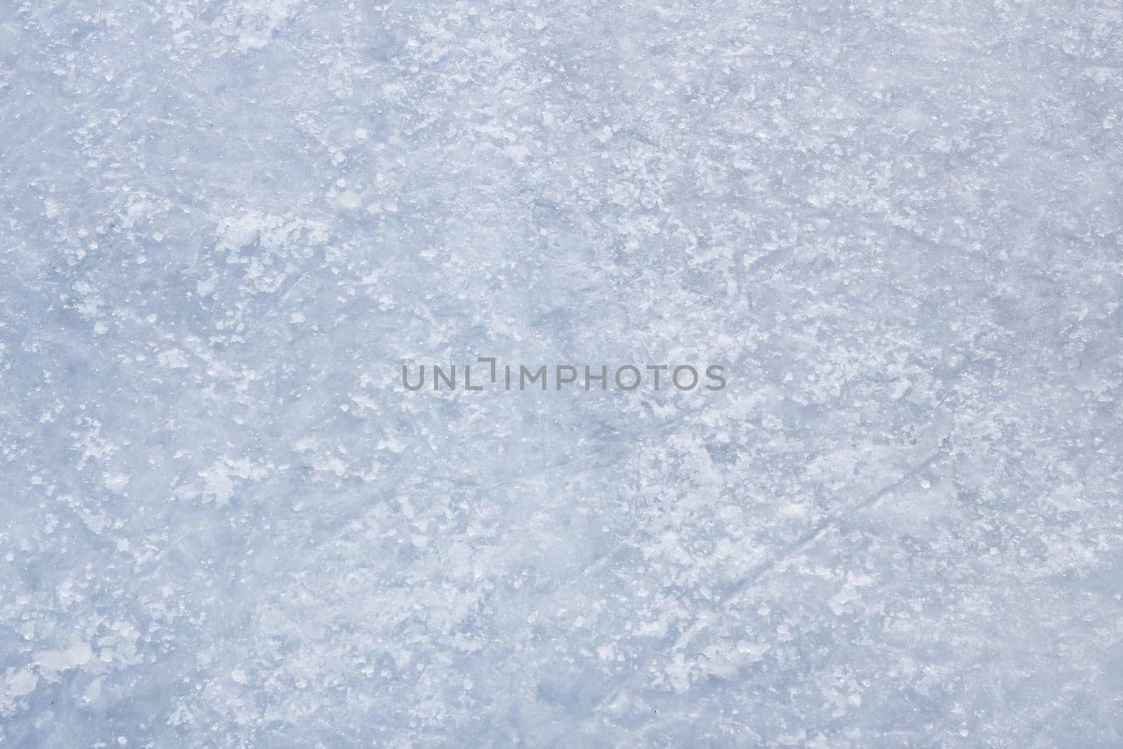 Ice background with skating and hockey marks, blue texture.