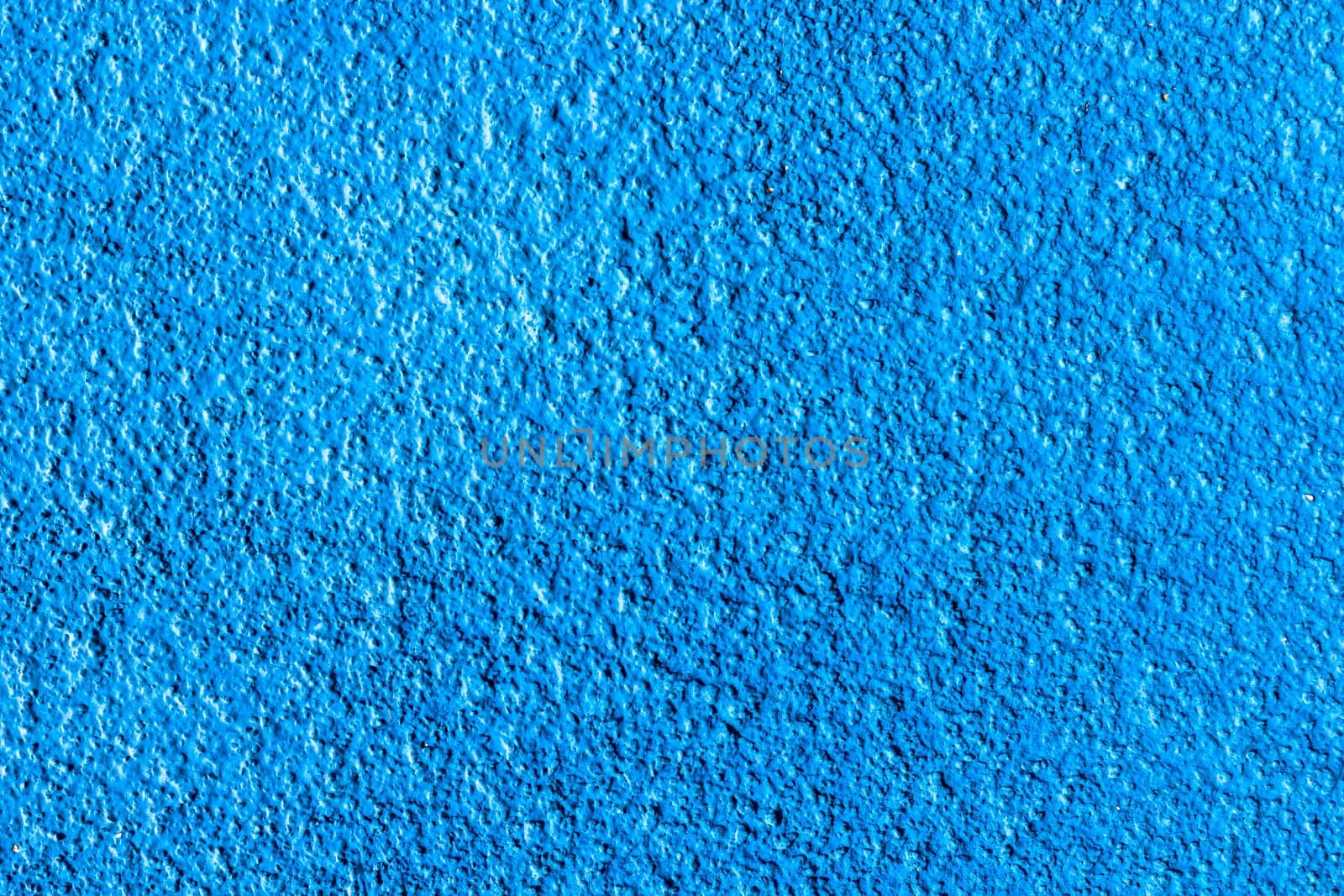 Blue cement wall texture for background and copy space for text. Blue paper background.