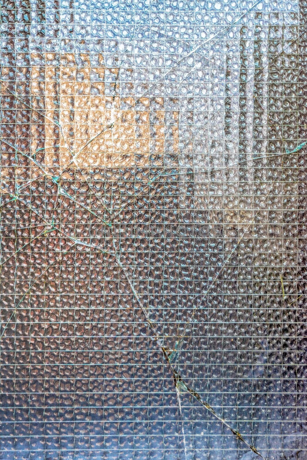 Window damage with lines of cracks on glass surface. Broken glass texture.
