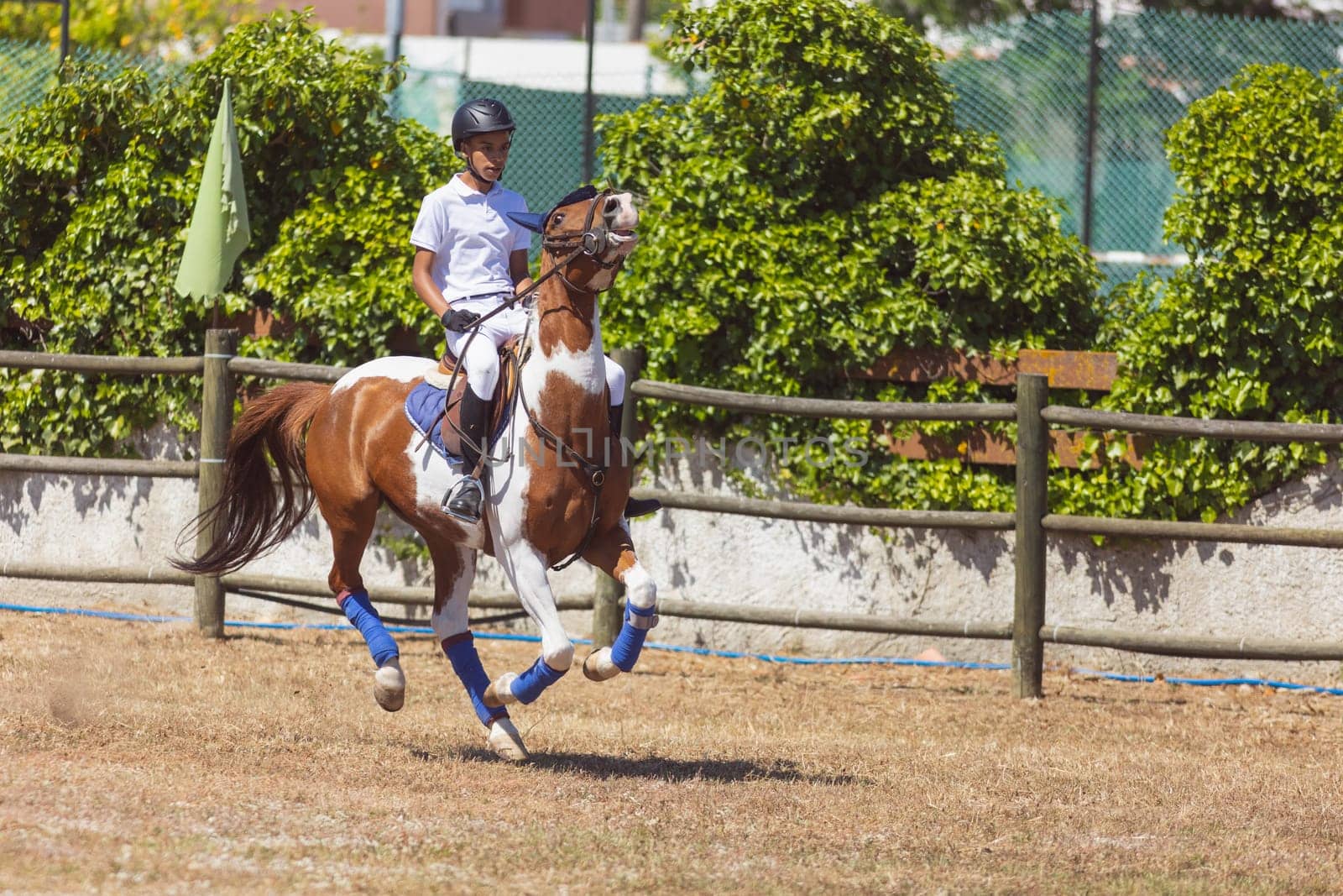 30 april 2023 Sobreda, Portugal: Festival Hipico da Sobreda - a little boy riding a horse at ranch. Mid shot