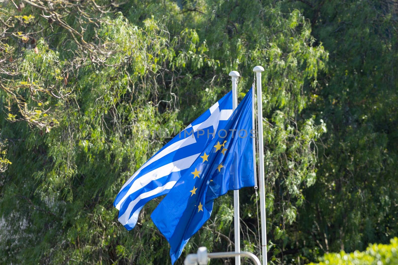 Flags of Greece and the European Union. Mid shot