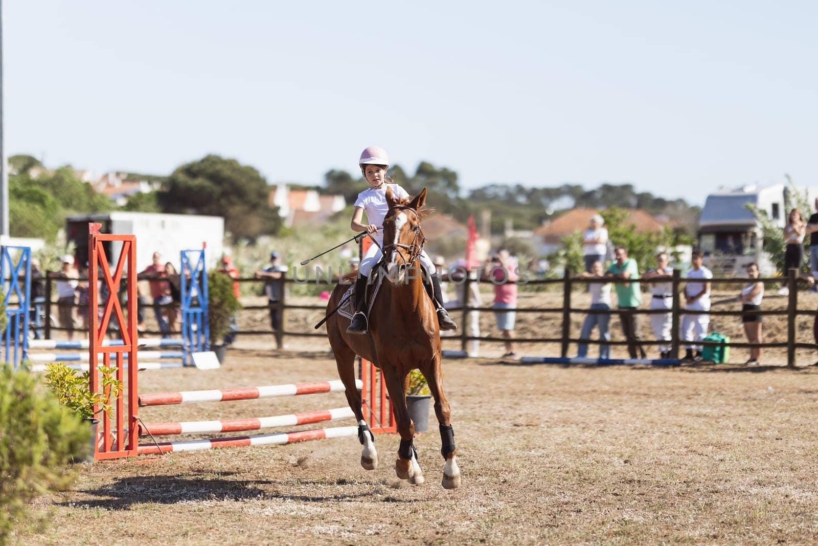 30 april 2023 Sobreda, Portugal: Festival Hipico da Sobreda - a little girl riding a horse at ranch. Mid shot
