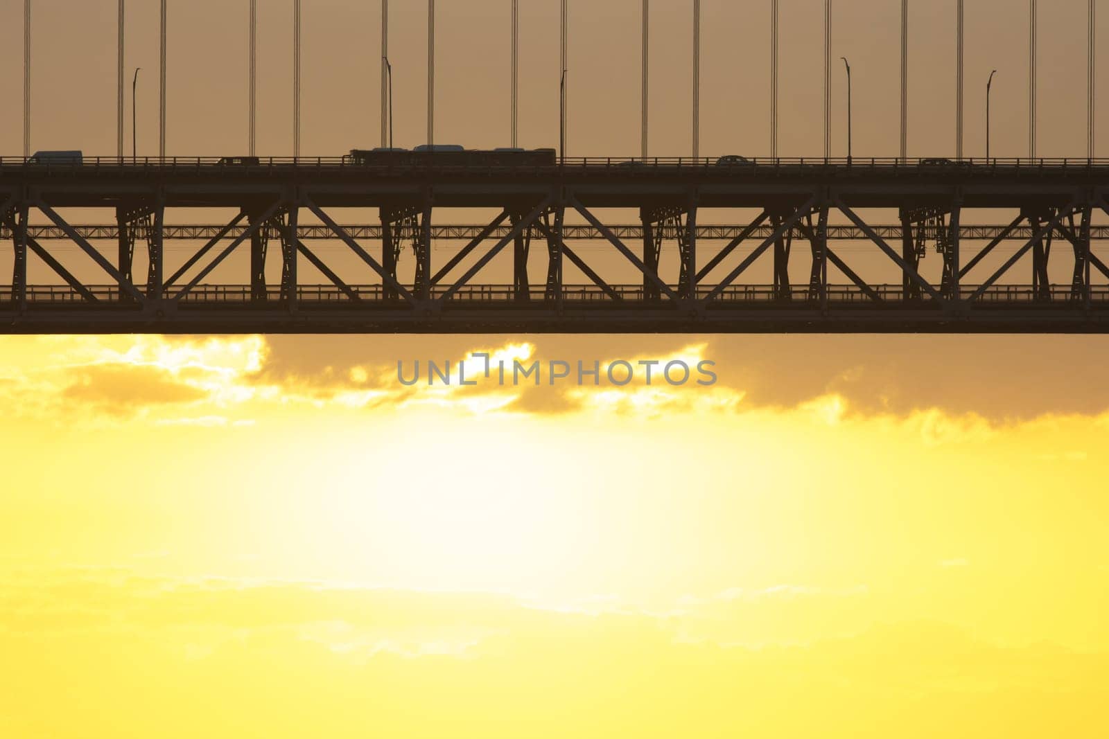 Bridge - Ponte 25 de Abril Lisbon Portugal - 25 april Bridge, cars and tracks moving over the bridge at sunrise, morning