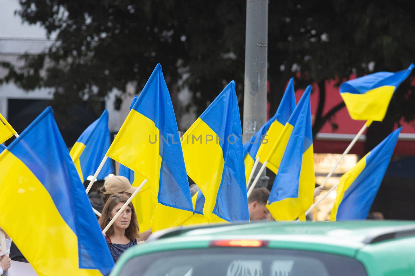 10-29-2022 LISBON, PORTUGAL: Ukrainian protest in Lisbon - people are holding lots of Ukrainian flags. Mid shot