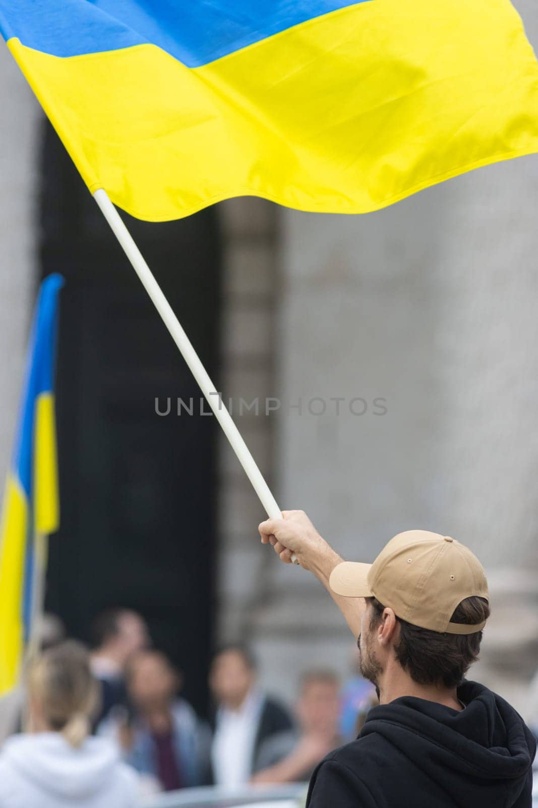 A man hold Ukrainian flag during protestA man hold Ukrainian flag during protest. Vertical shot