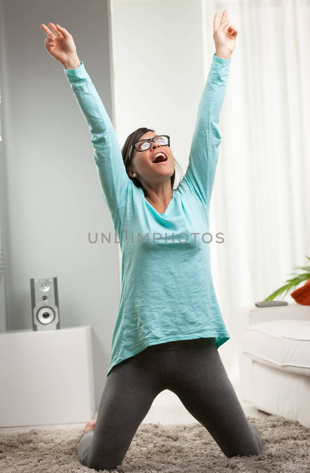 woman feeling successful for some winning reason in her house, precisely in her living room