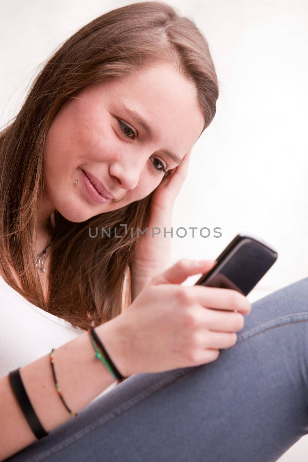 young girl focused on texting with her mobile phone