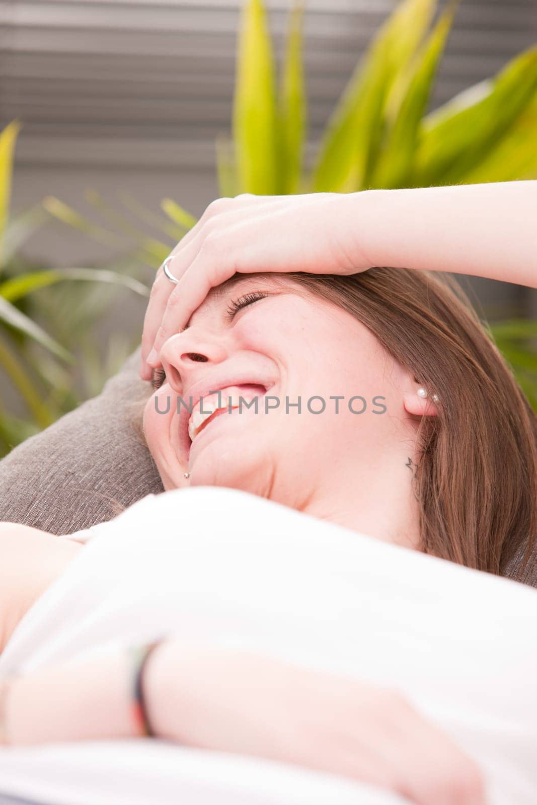 very happy girl laughing on her sofa