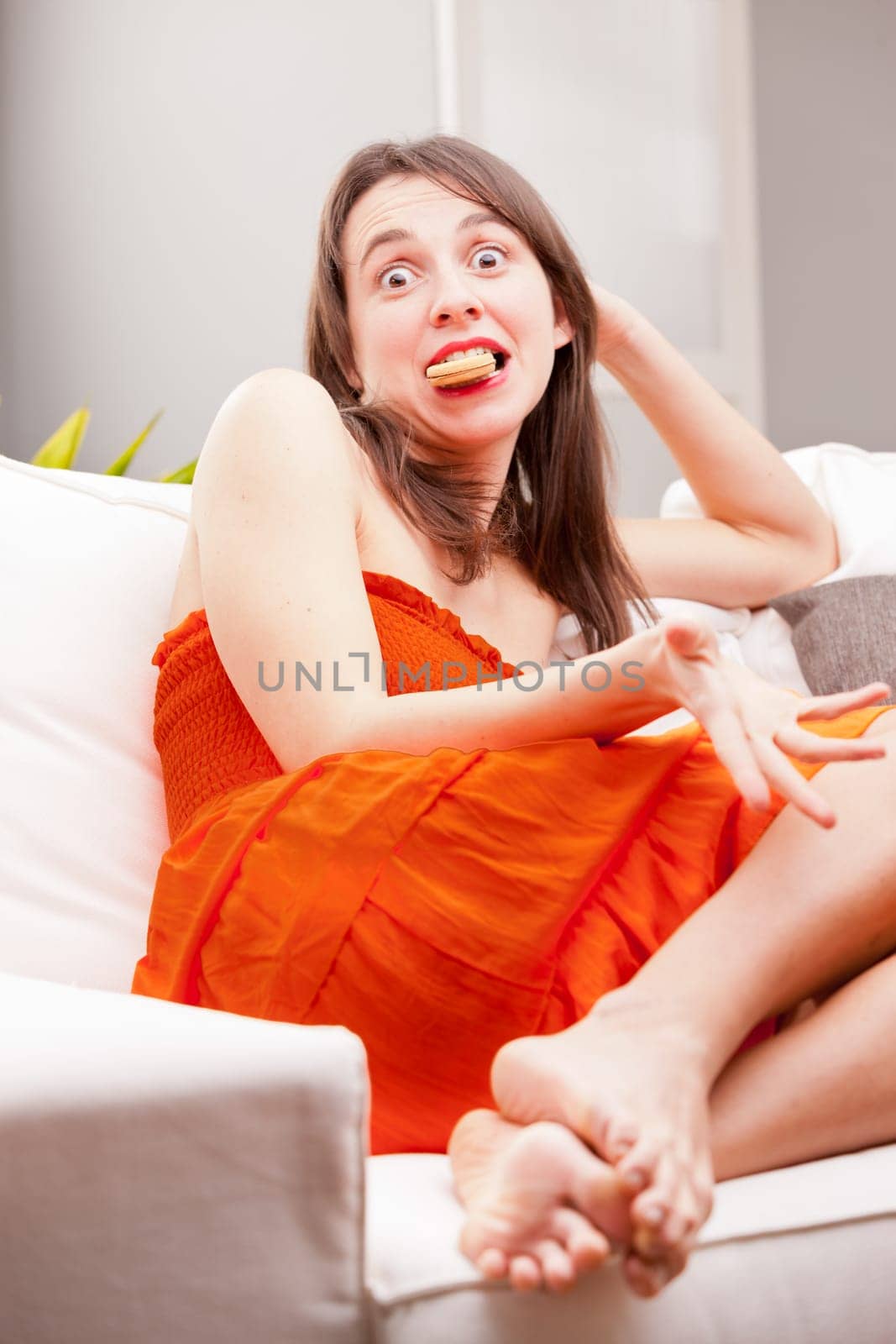 funny face of a young woman eating caught eating cookies when she had to diet