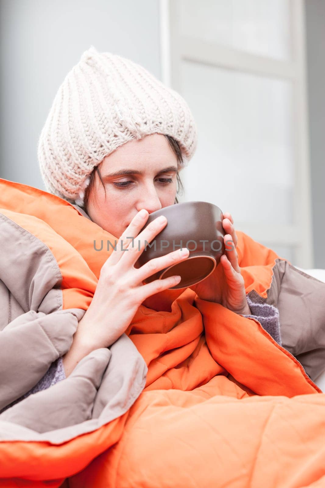 funny exaggeration concept of an ill woman that has the flu as she drinks a hot chicken broth