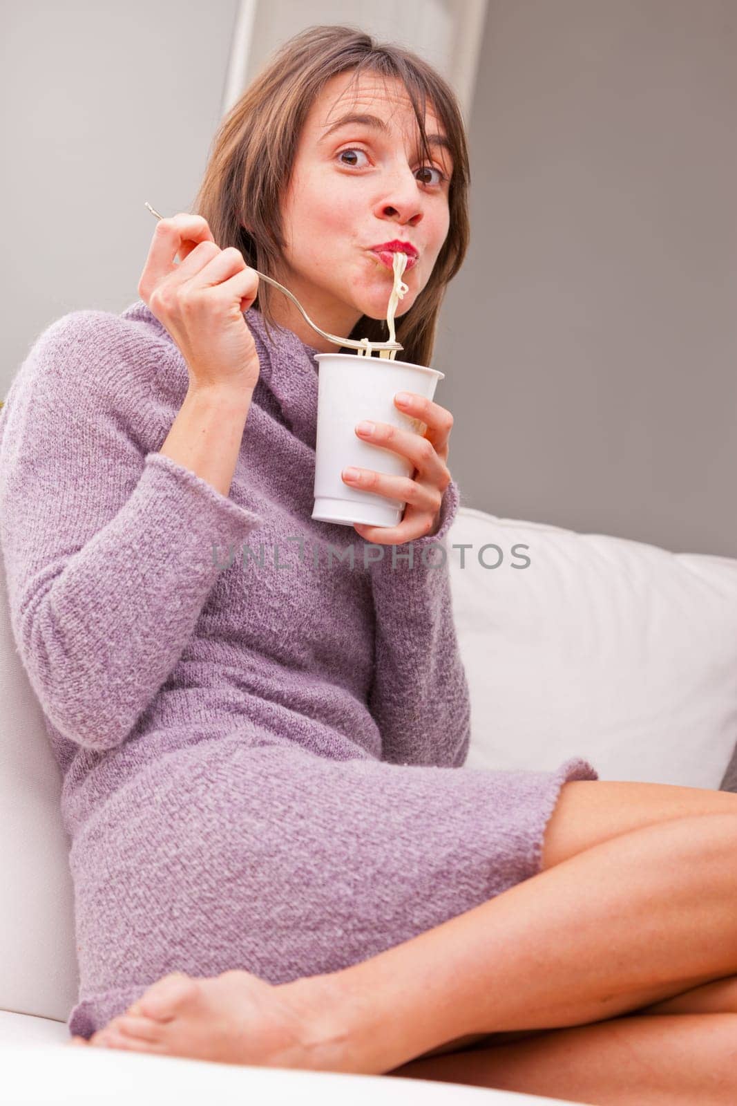 happy woman slurping her noodles in relax