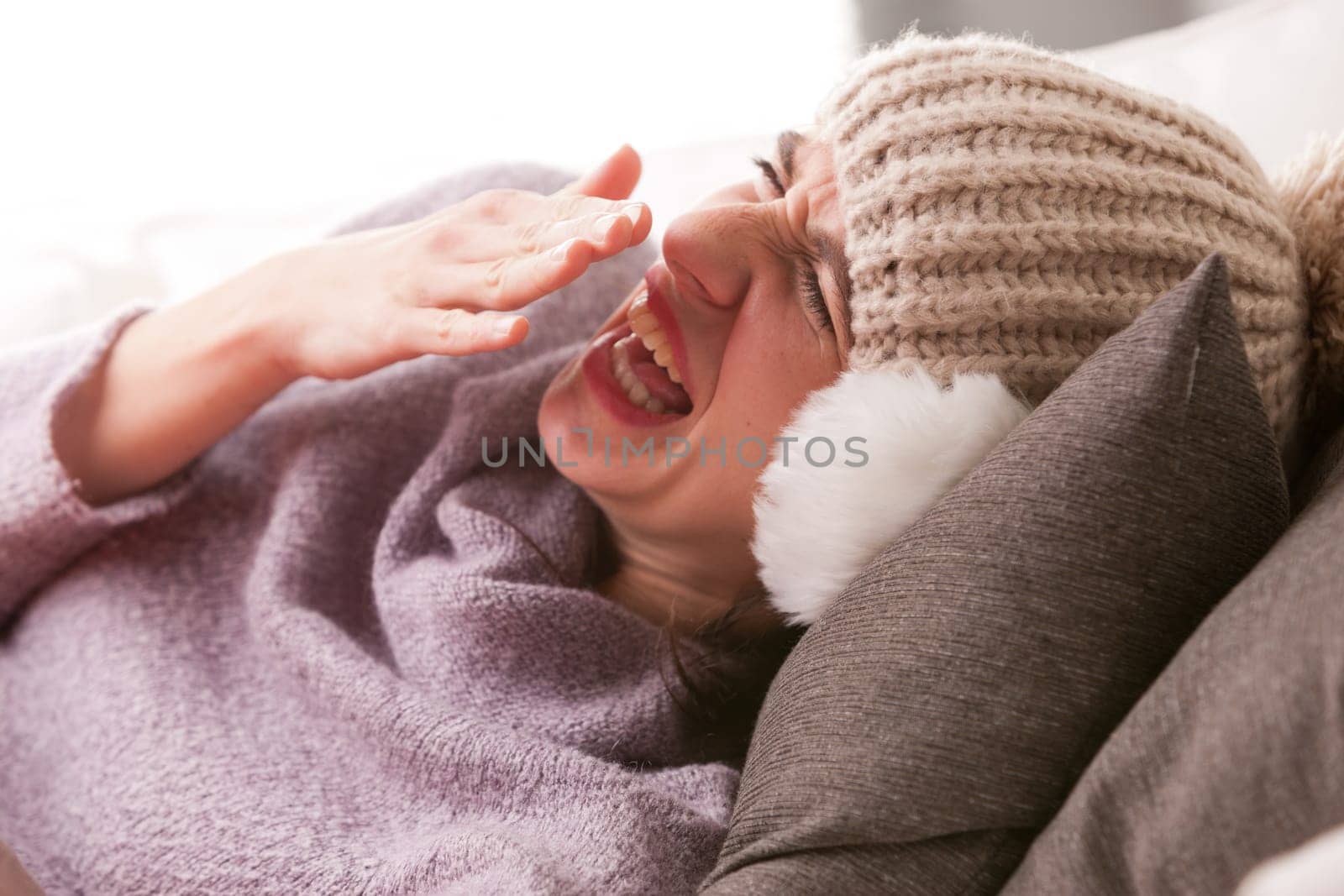 headache and illness of a young woman on a couch in her living room