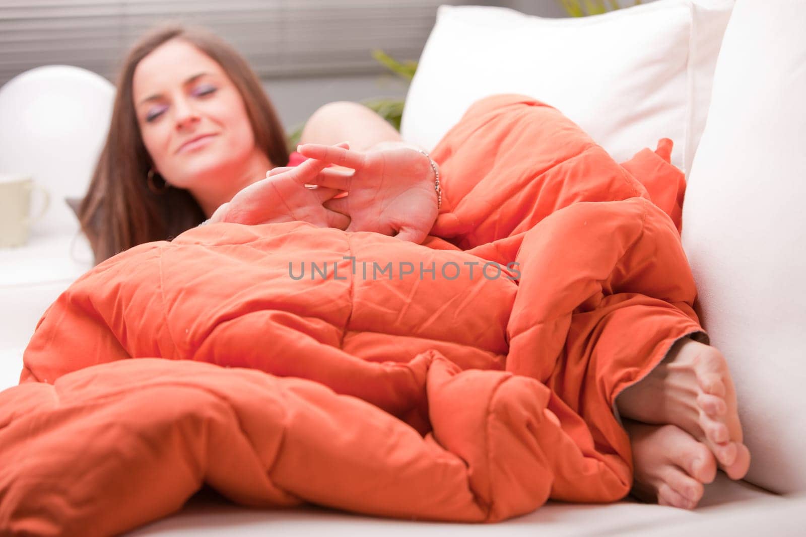 girl stretching and yawning in the morning on her couch in her living room
