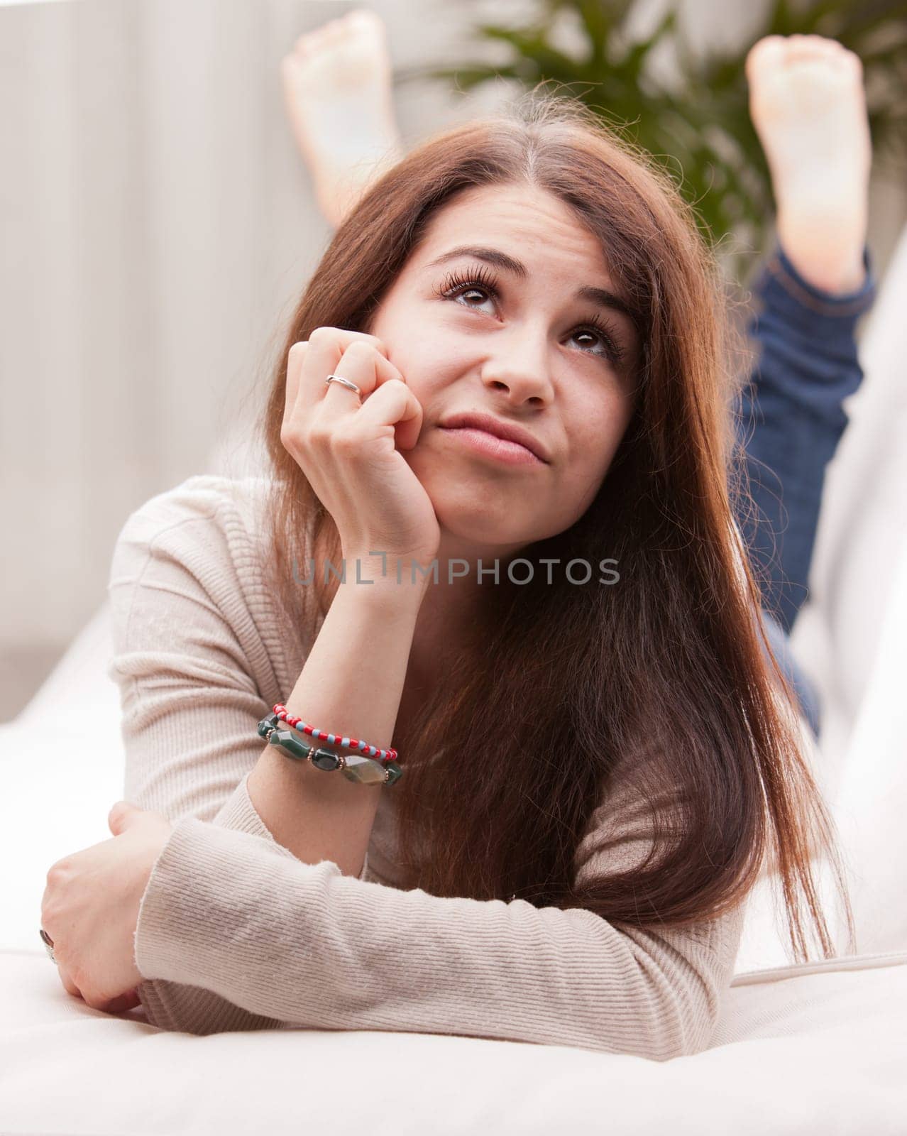 girl wondering something that could happen on a sofa or somewhere else in her life or in the world