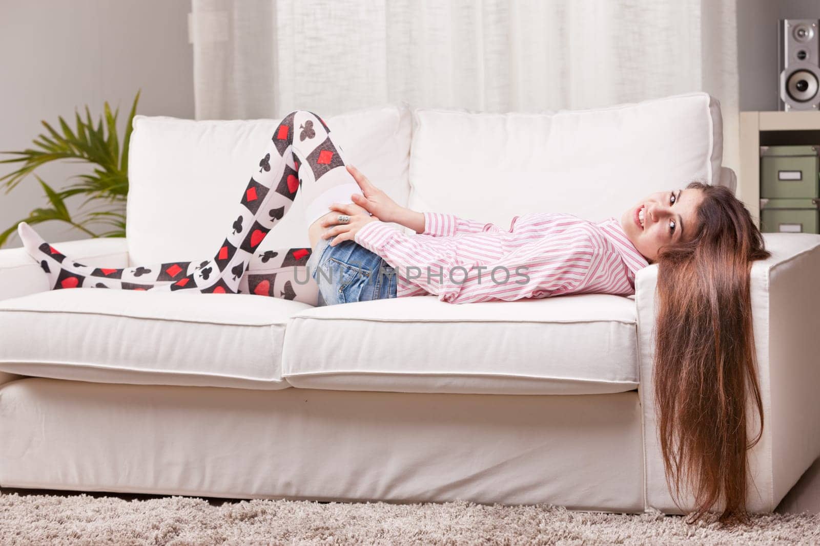 girl talking to the camera from a couch in her living room