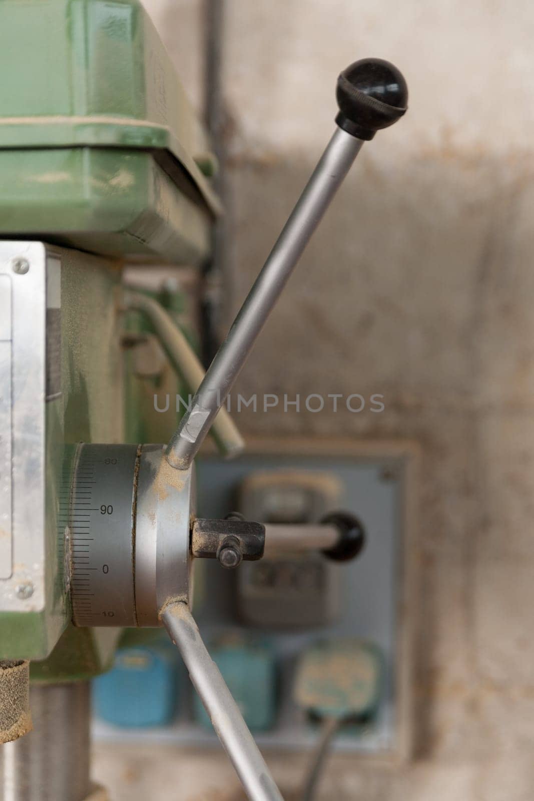 detail of a boring machine in a carpenter workshop with a very shallow depth of field