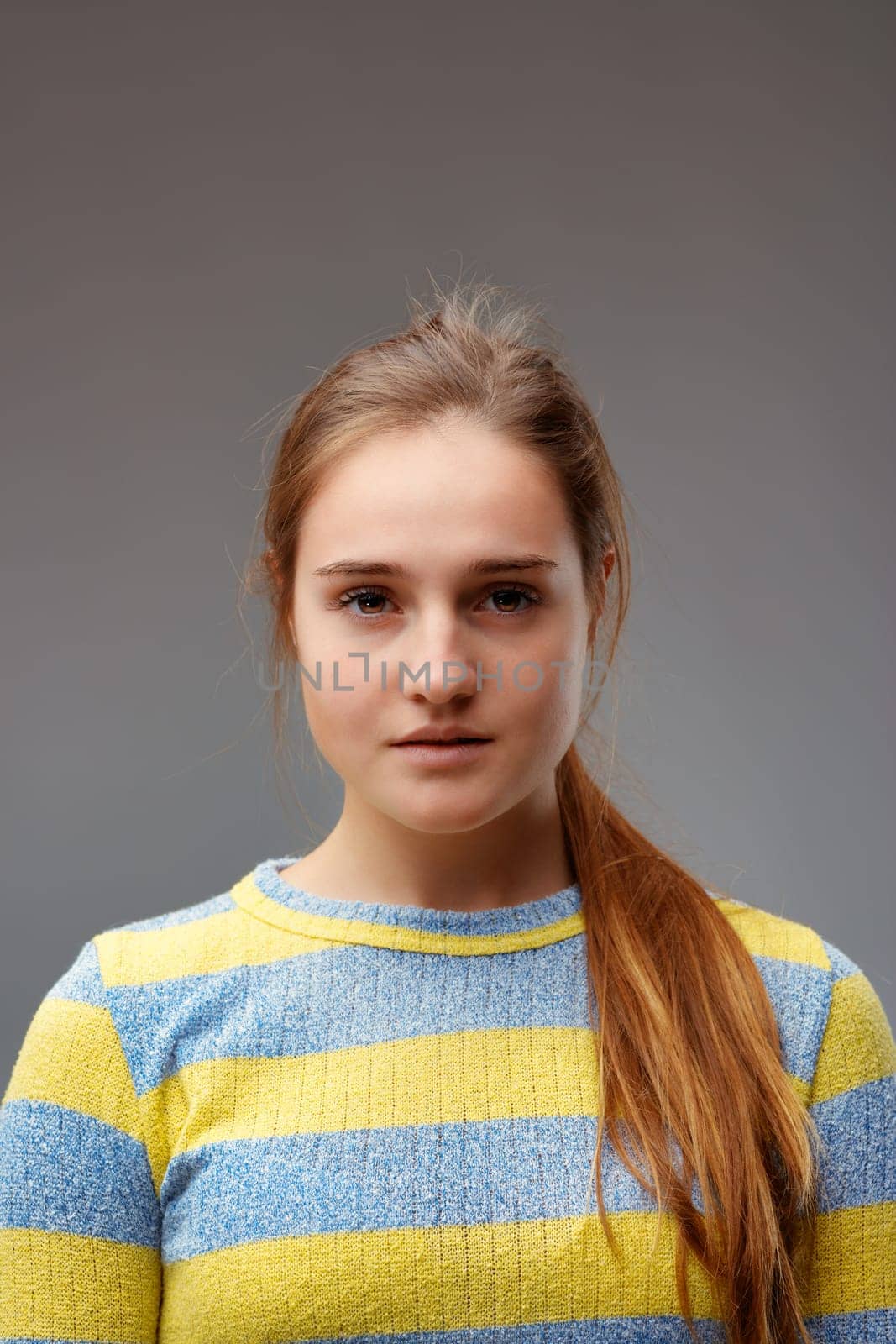 portrait of a serious and self-confident young woman, or slightly angry but determined and courageous