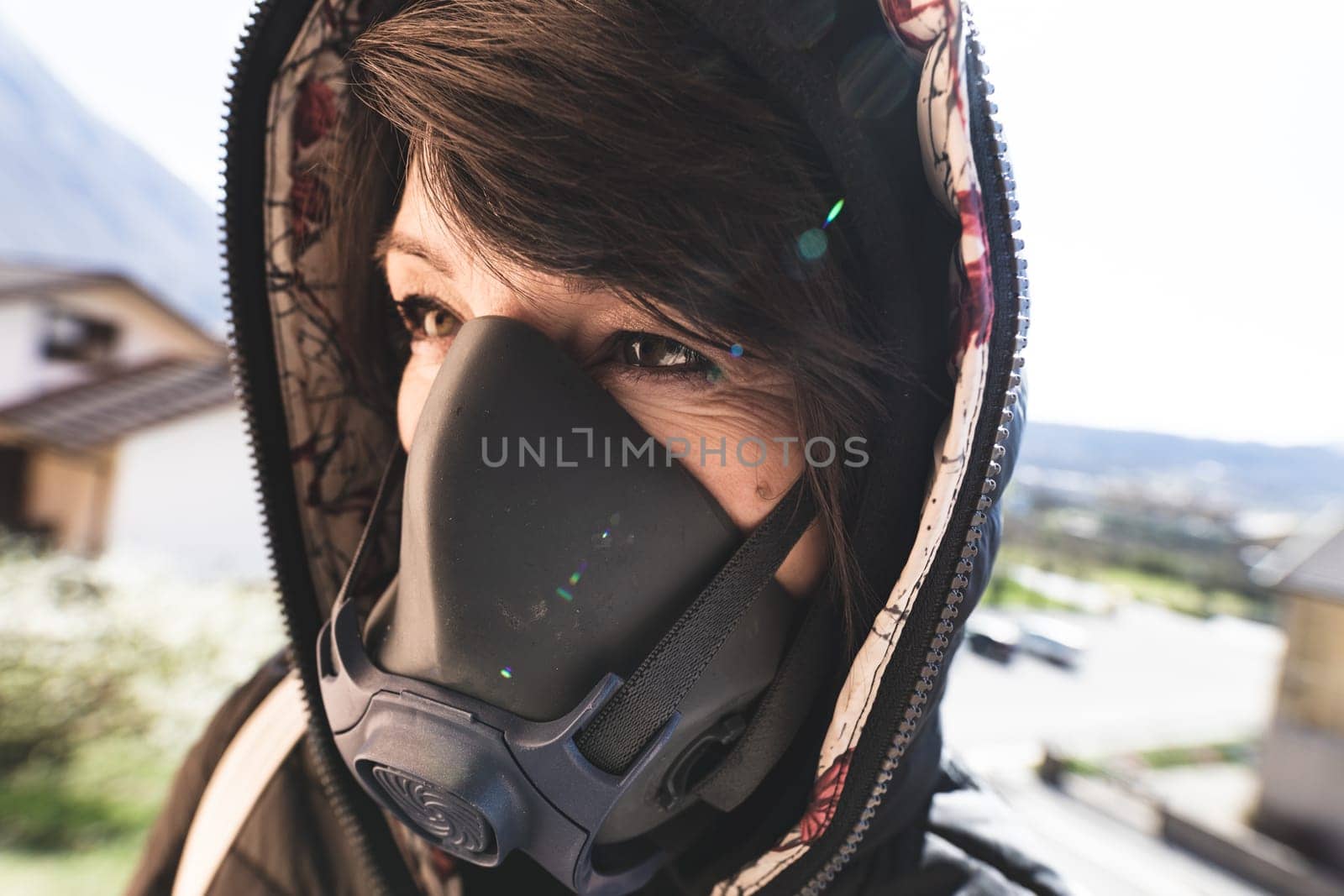 woman with a gas mask walking on the city streets surviving a corona virus pandemic or post atomic world