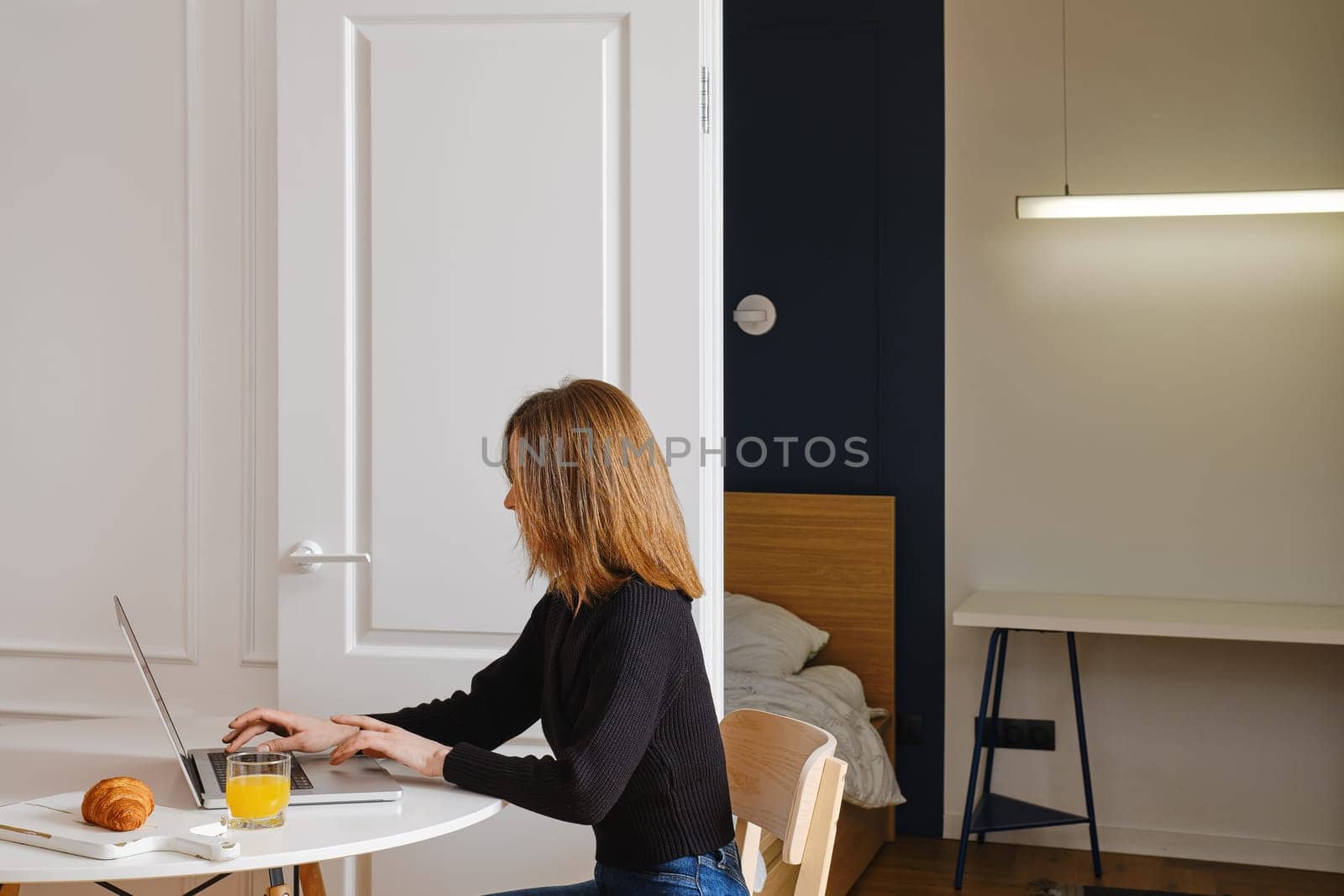 Woman filling in Visa application form from home online