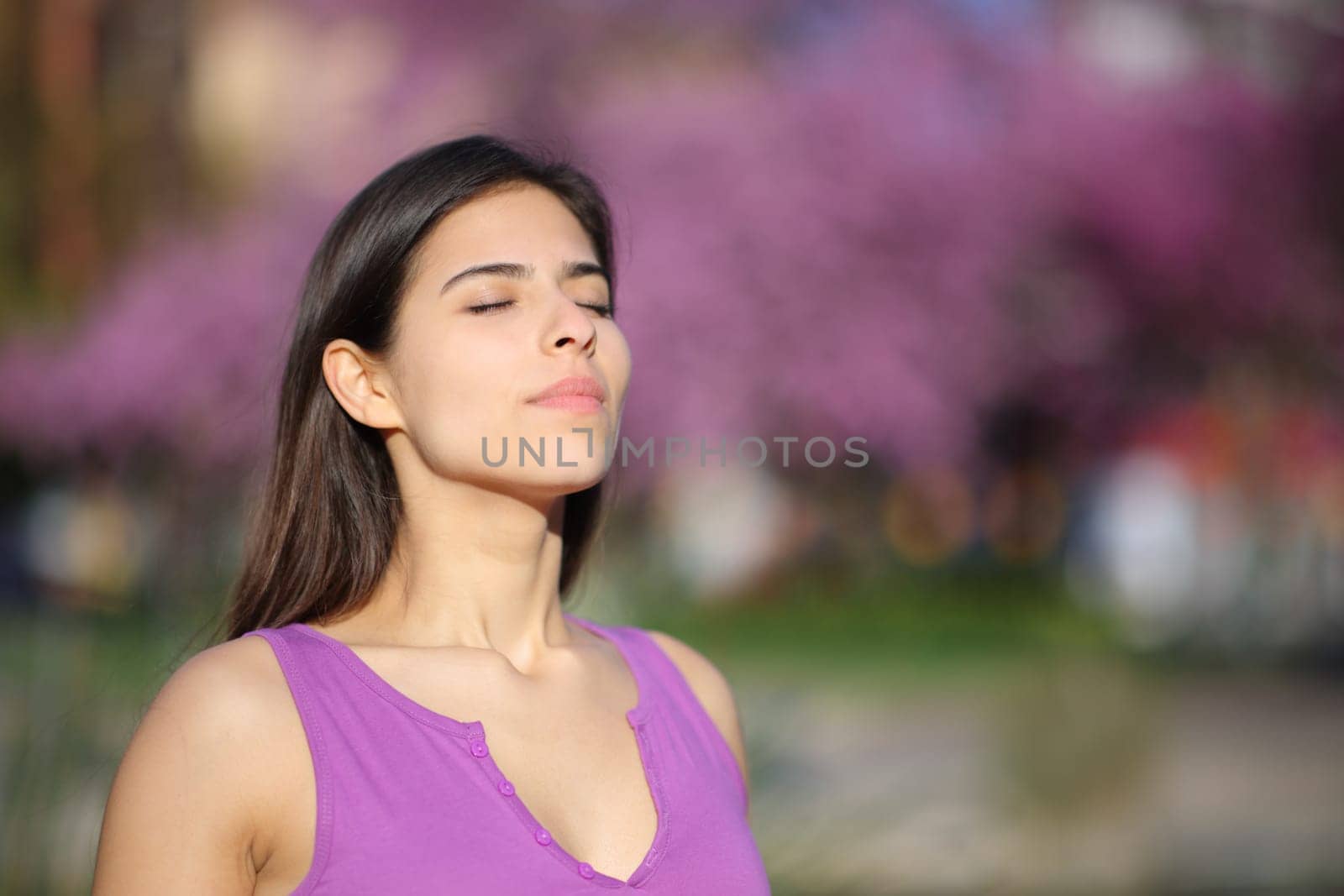 Woman on violet breathing fresh air in a park