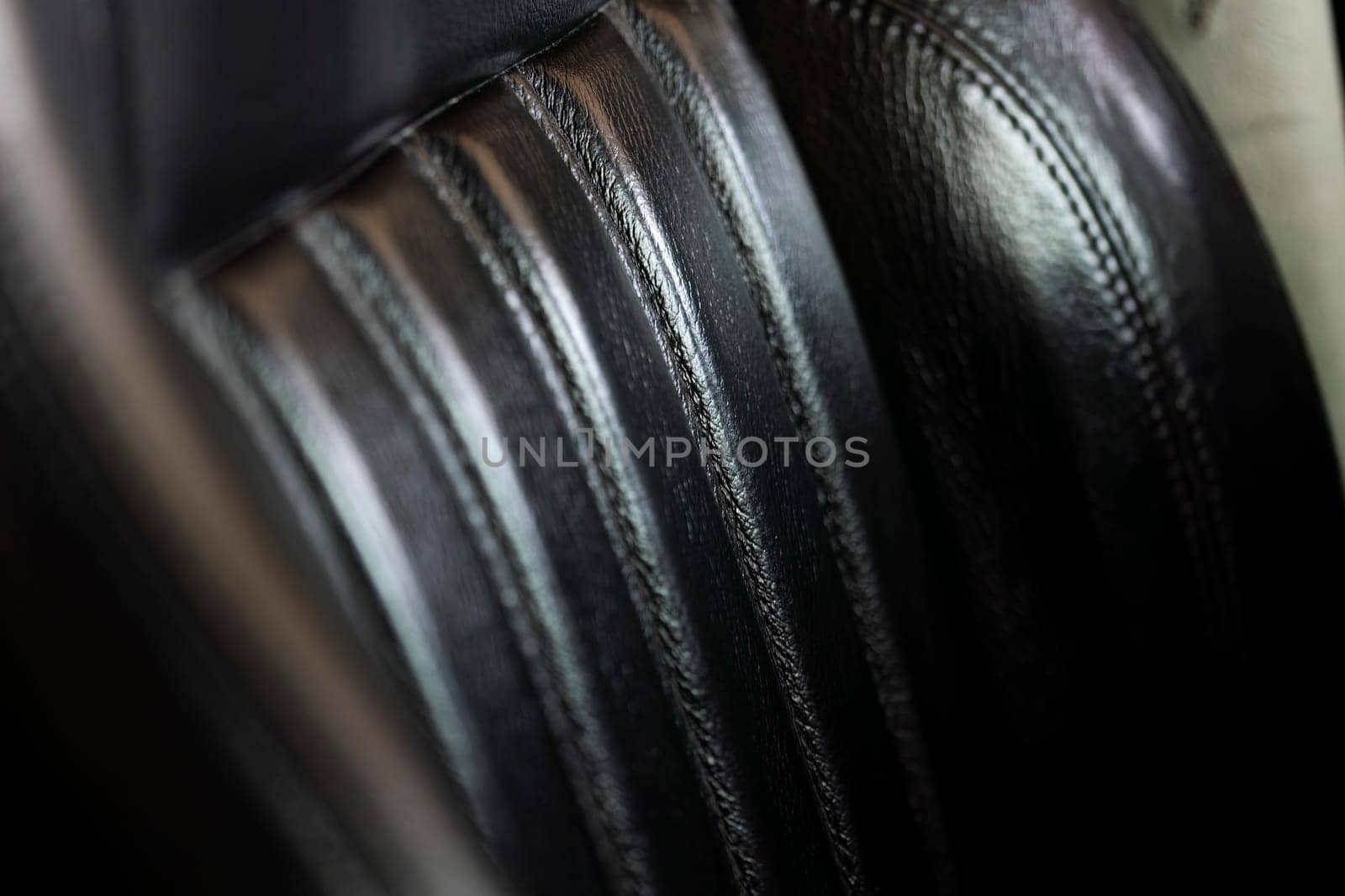 Close-up showcasing the intricate texture and design of a leather seat in a sports car.