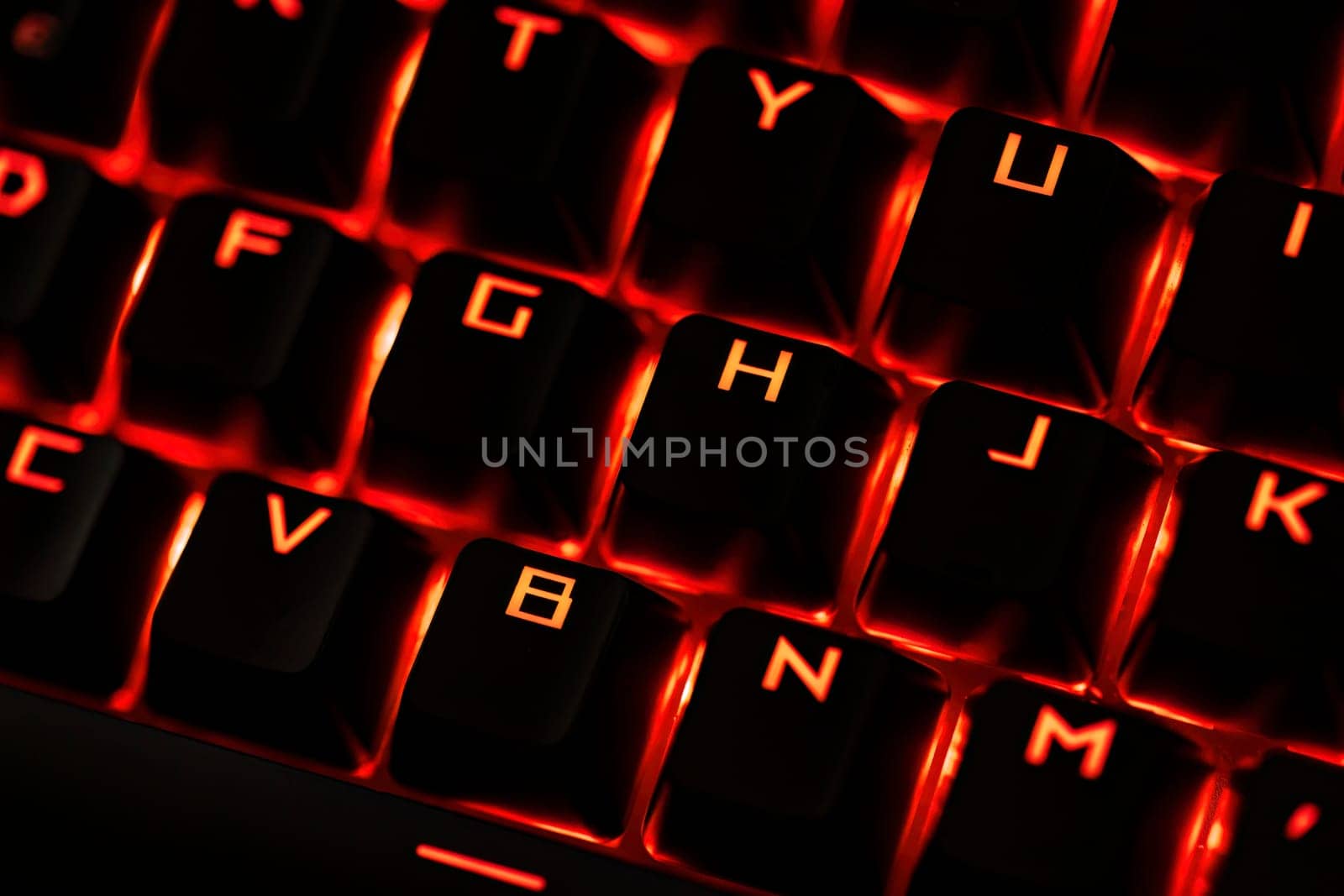 Close-up of a gaming keyboard with illuminated backlit keys, highlighting precision and design.