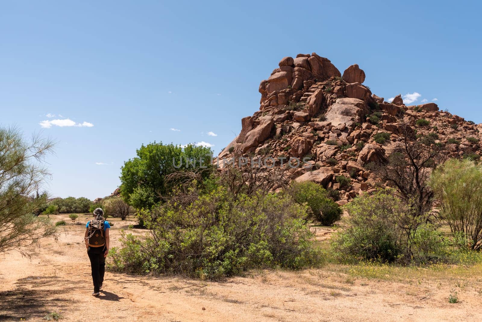 A hiker at the famous Napoleon Hat in the Tafrout valley in the Anti-Atlas mountains, Morocco