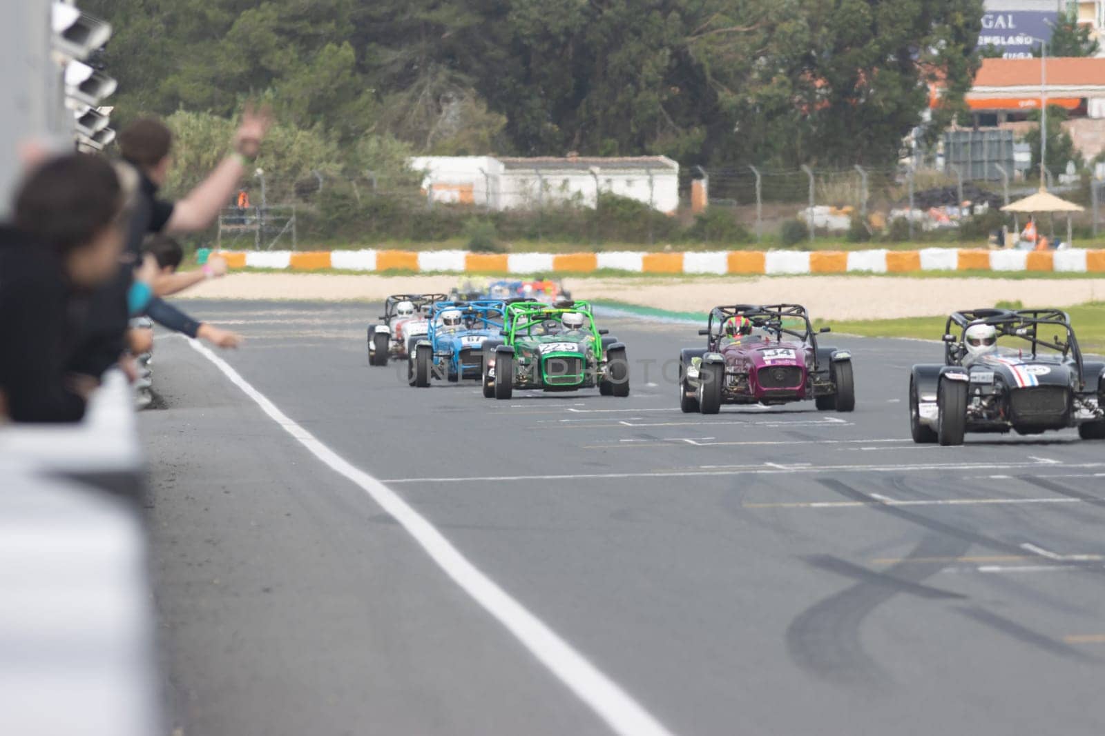 11-20-2022 PORTUGAL, LISBON: Caterham festival - karts of different colors drive along the race track. Mid shot