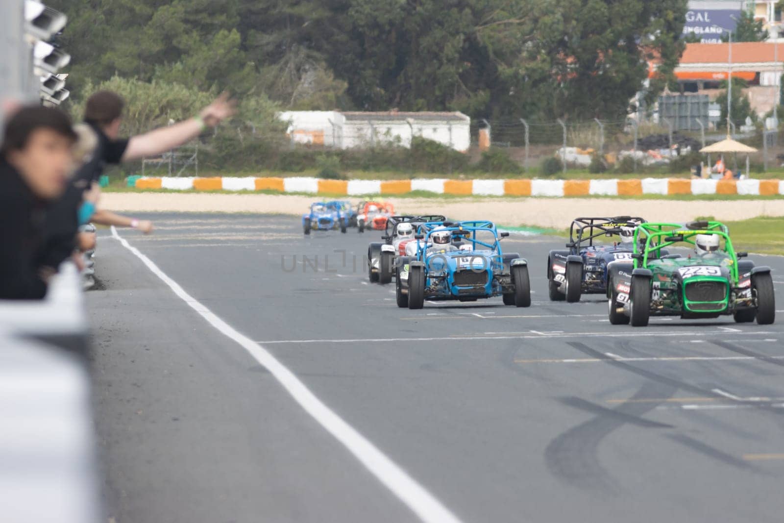 11-20-2022 PORTUGAL, LISBON: Caterham Festival Estoril - karts of different colors drive along the race track. Mid shot