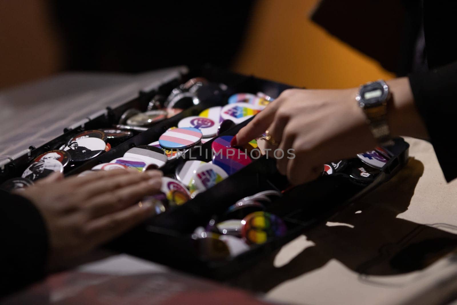 PORTUGAL, LISBON 11-25-2022: the March for the End of Violence Against Women - a box with LGBT pride pins. Mid shot