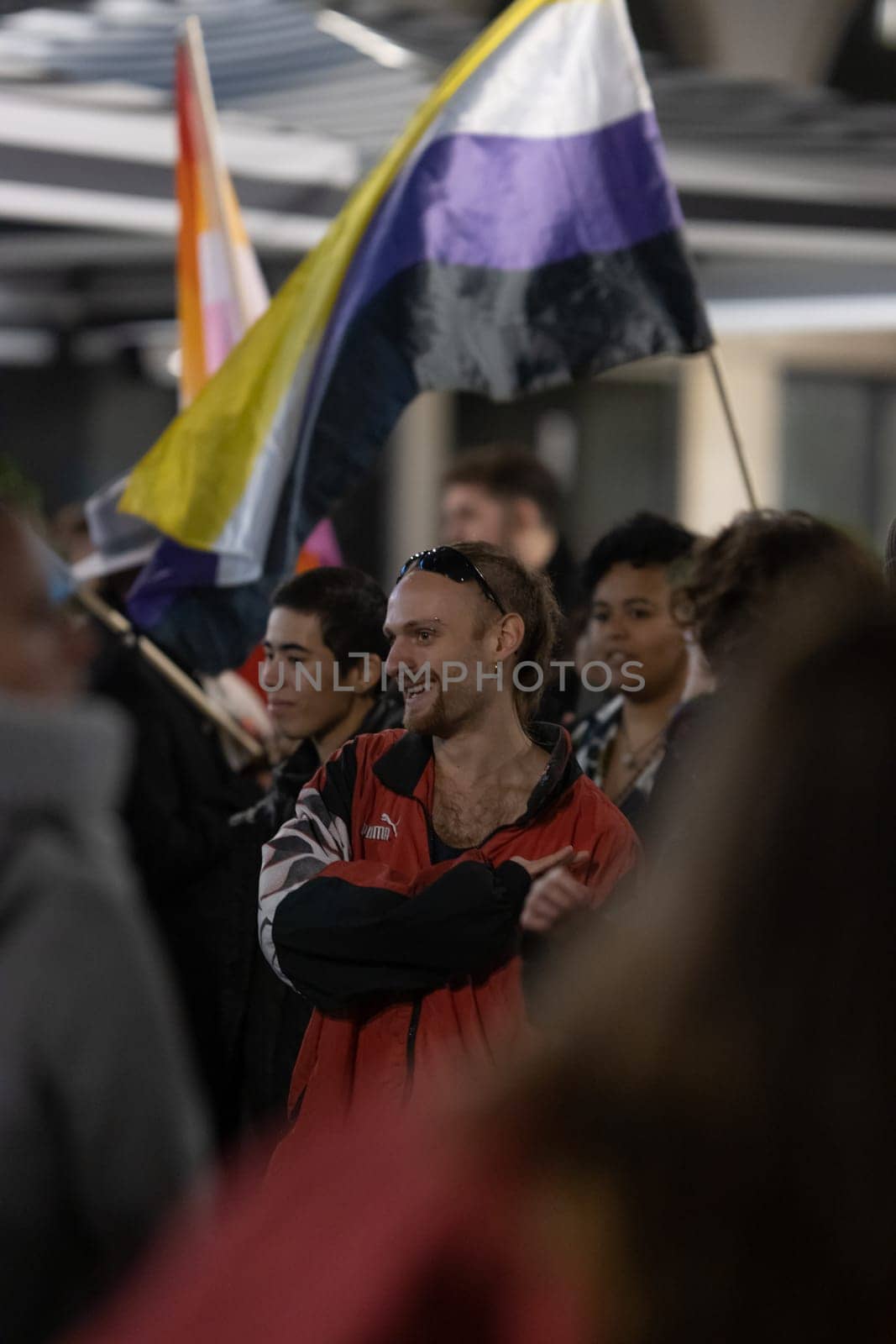PORTUGAL, LISBON 11-25-2022: the March for the End of Violence Against Women - smiling man standing in the crowd. Vertical shot