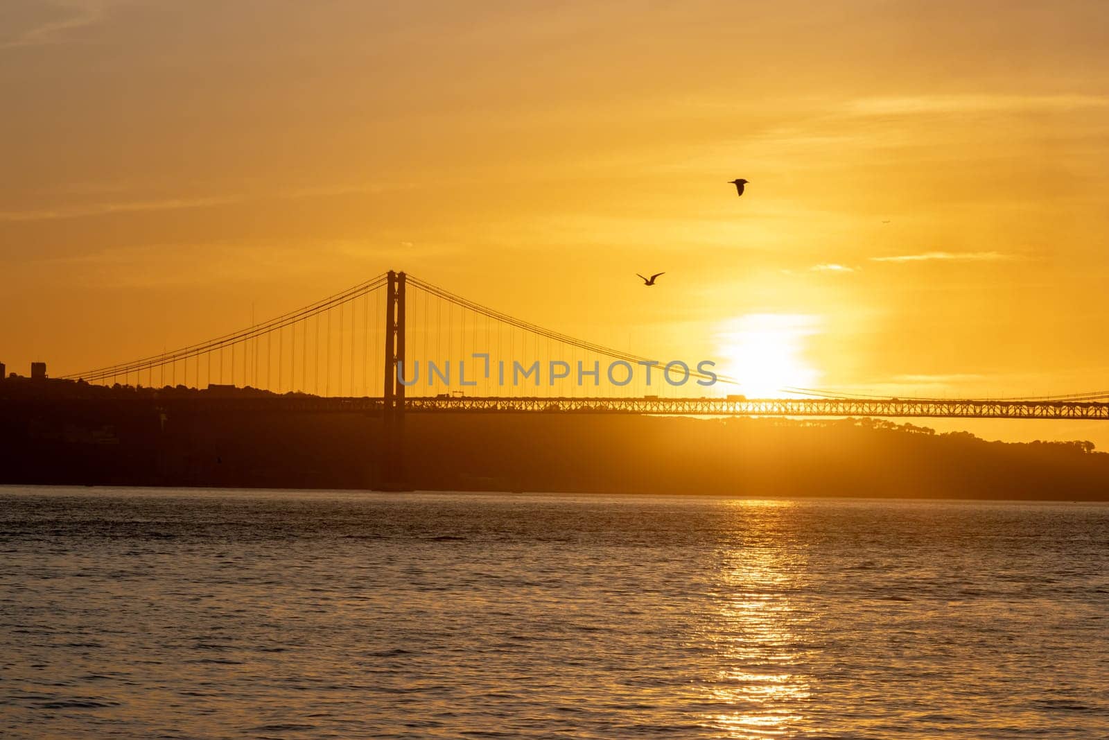 Bright orange sunset over the river. Mid shot