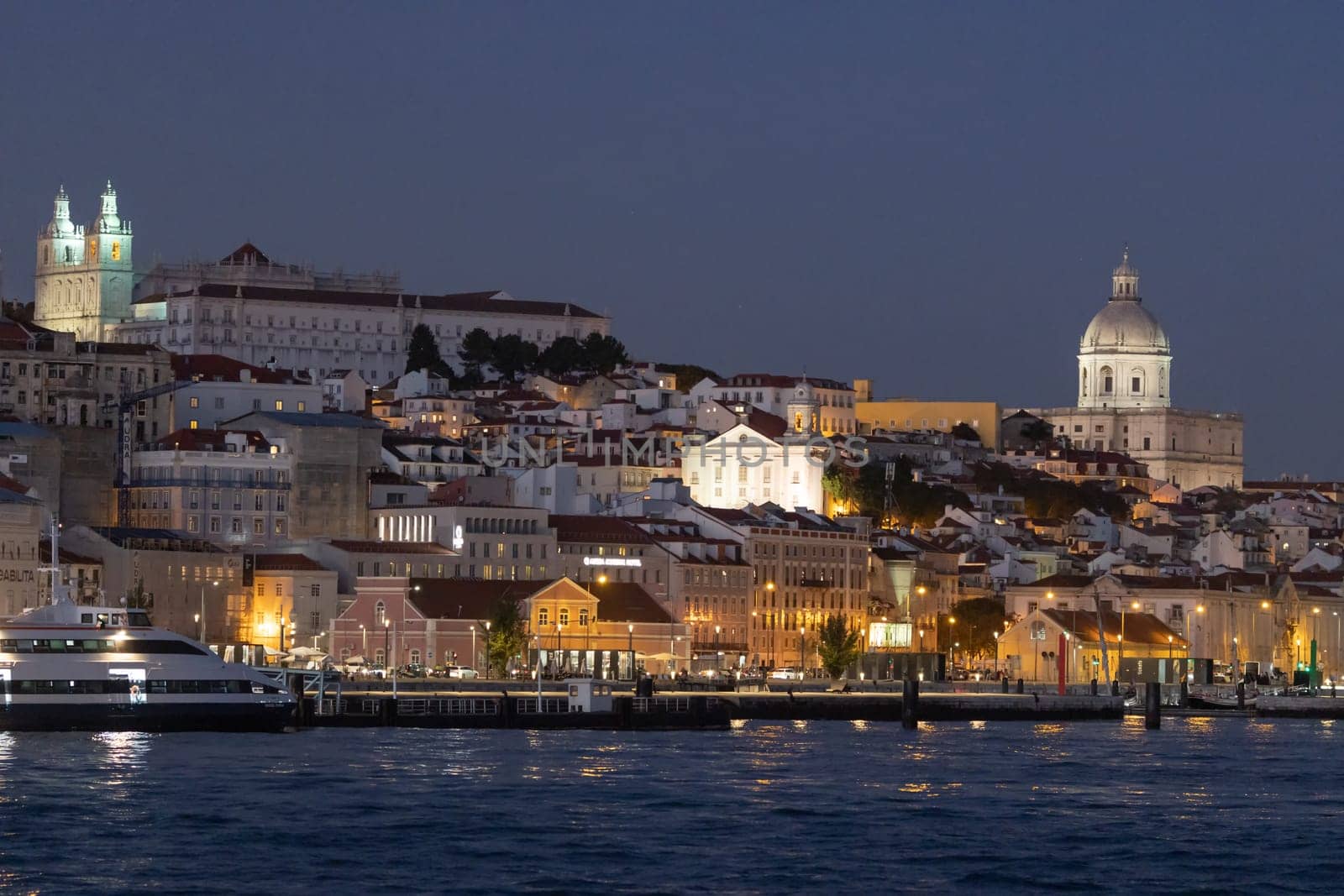 PORTUGAL, LISBON 11-25-2022: Lisbon at night and tagus river - alfama district. Mid shot