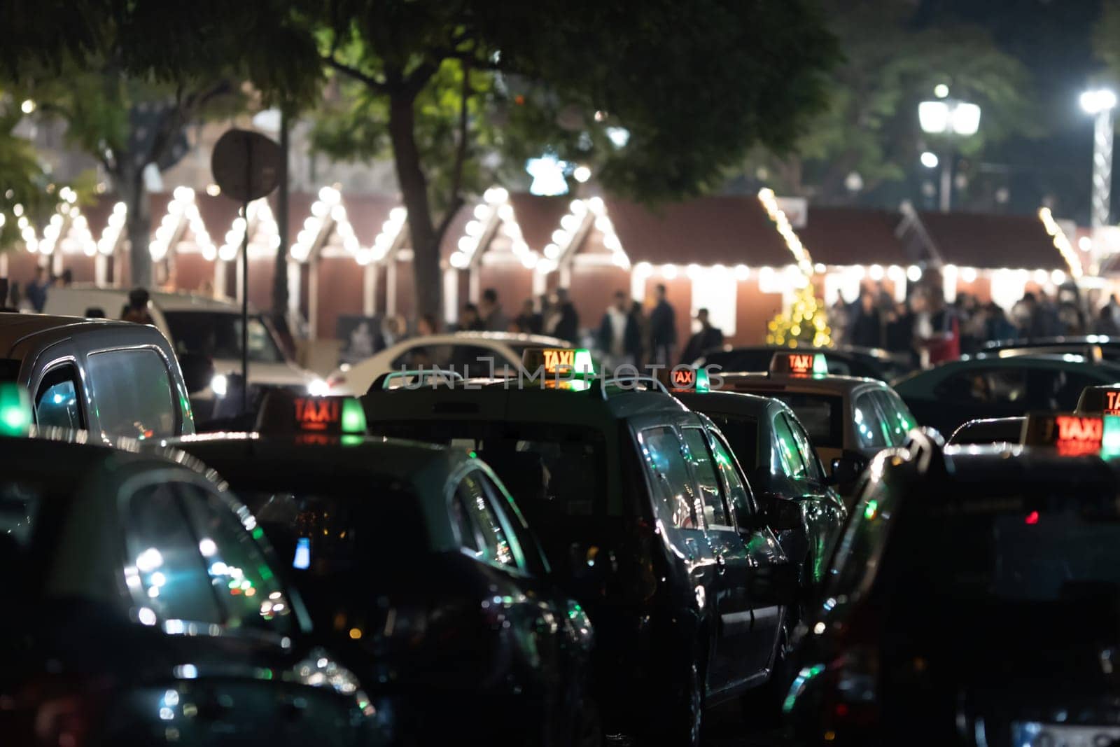 Parked taxi cars in Europe at night. Mid shot