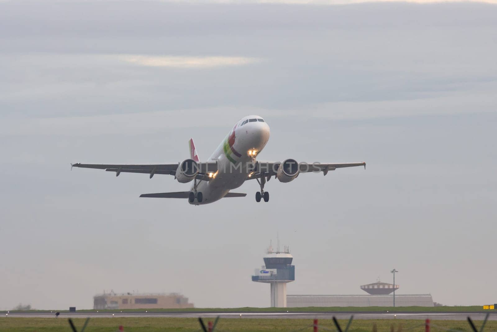 30 November 2022 PORTUGAL, LISBON: an AIRPORTUGAL airplane gains altitude from the runway. Mid shot