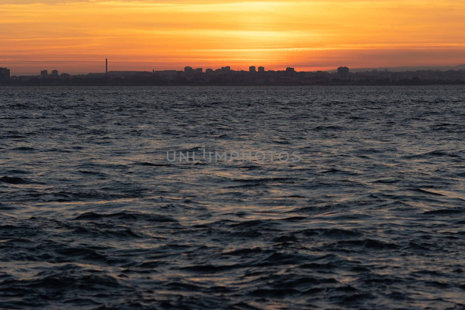River water surface at an orange sunset. Mid shot