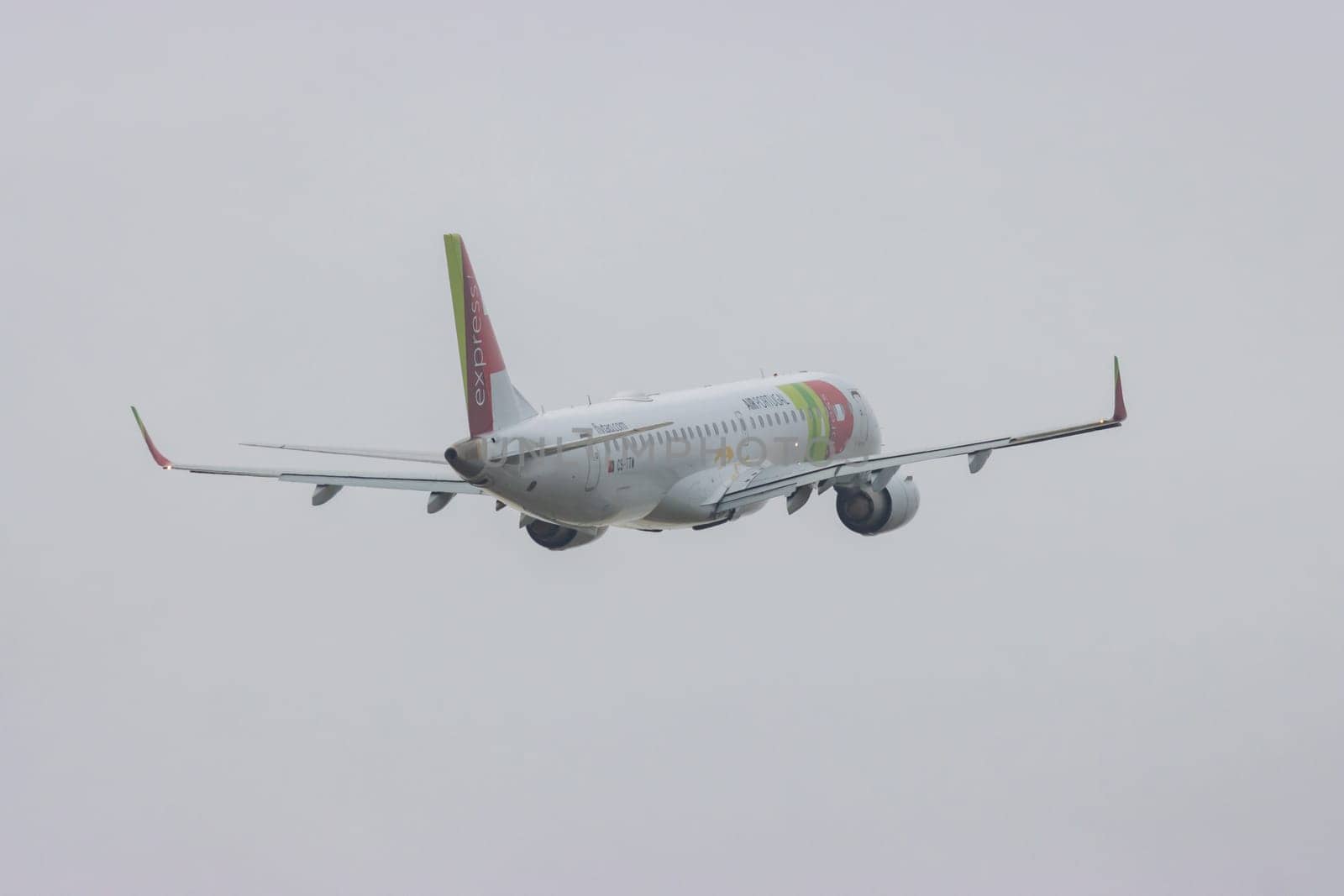 30 November 2022 PORTUGAL, LISBON: an AIRPORTUGAL airplane flying in grey sky. Mid shot